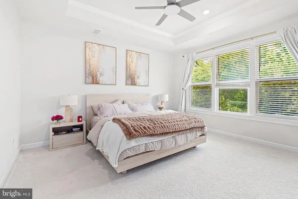 a spacious bedroom with a bed and a large window