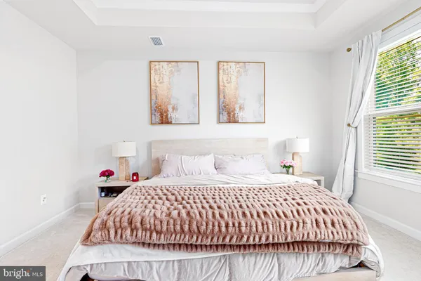 a bedroom with a bed and window