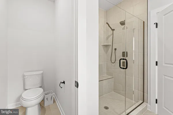 a bathroom with a toilet and shower