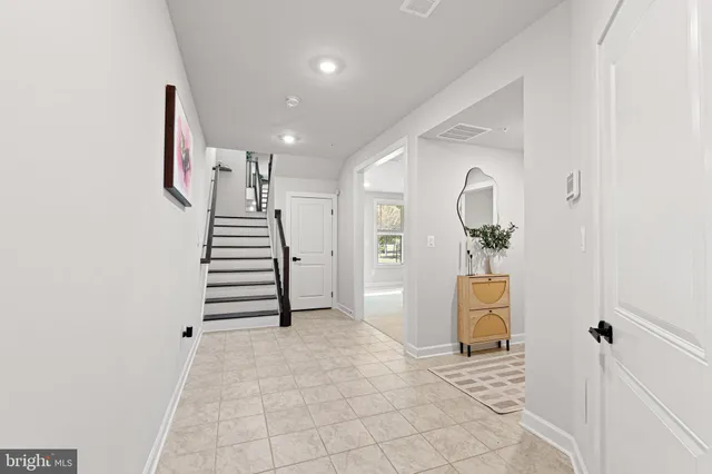 an entryway in a hall with a sink