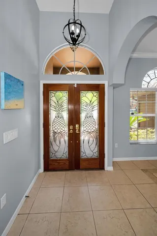 a living room with furniture and a chandelier