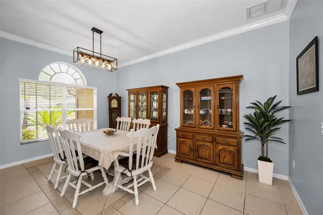 a kitchen with kitchen island granite countertop wooden cabinets stainless steel appliances and a window