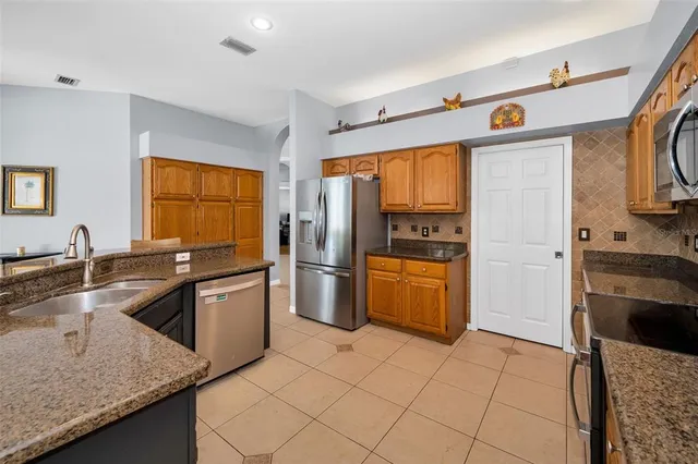 a bathroom with a granite countertop sink a mirror and a bathtub