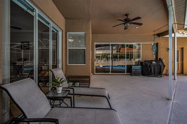a view of a patio with a dining table and chairs with a fire pit