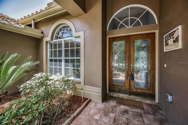 a living room with furniture a rug and a large window