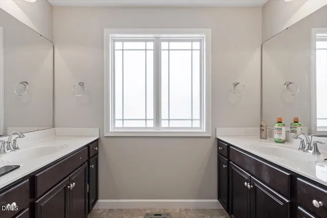 a close view of sink and mirror with window