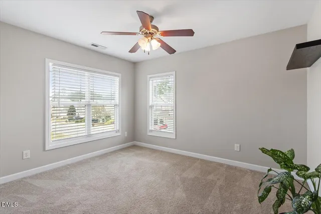 a bathroom with a granite countertop toilet sink and mirror