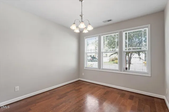 a living room with furniture kitchen view and a chandelier