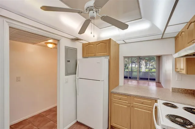 a kitchen with a refrigerator a sink and cabinets