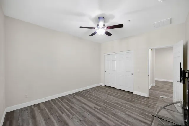 a bathroom with a granite countertop sink a mirror and a bathtub