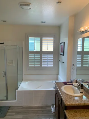 a bathroom with granite countertop a sink and a mirror