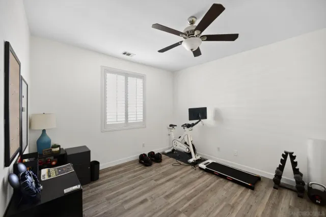 a view of a workspace with furniture and a flat screen tv