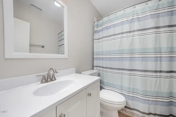 a bathroom with a sink toilet and vanity