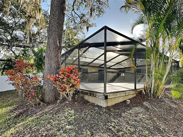 a backyard of a house with table and chairs