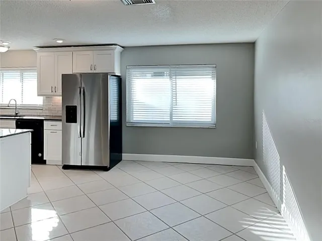 a view of a kitchen with a refrigerator a sink and dishwasher