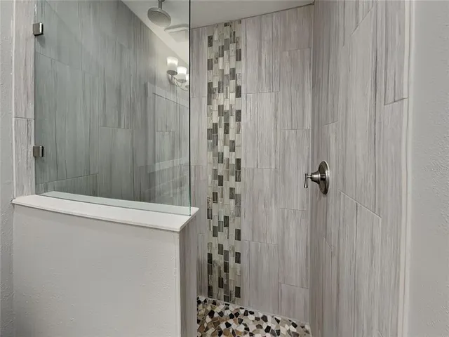 a bathroom with a shower and a sink
