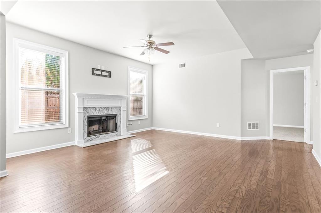 4237 Water Mill Drive Buford, GA 30519 - Photo 13 of 35 a view of an empty room with wooden floor fireplace and a window