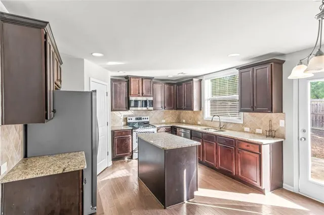 a kitchen with a sink stove and refrigerator