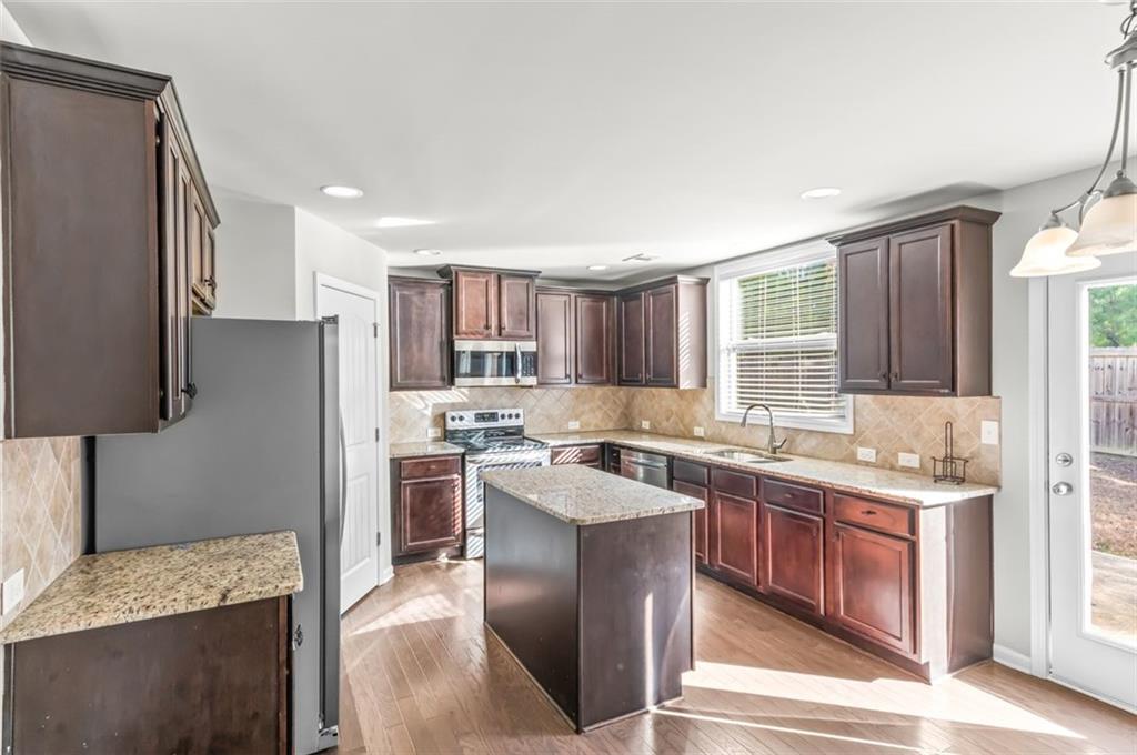 4237 Water Mill Drive Buford, GA 30519 - Photo 15 of 35 a kitchen with a sink stove and refrigerator