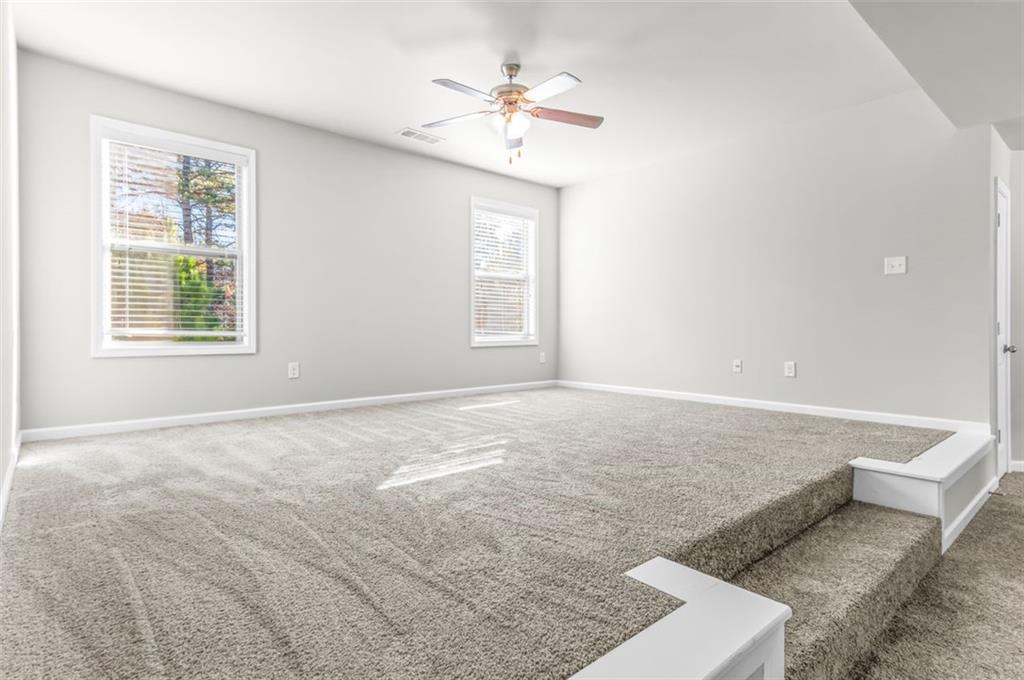4237 Water Mill Drive Buford, GA 30519 - Photo 18 of 35 an empty room with windows and ceiling fan