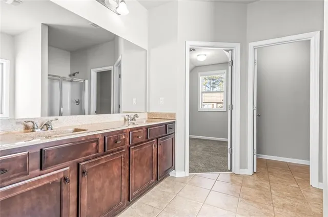 a spacious bathroom with a granite countertop sink and a mirror
