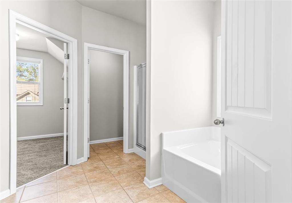 4237 Water Mill Drive Buford, GA 30519 - Photo 23 of 35 a bathroom with a bathtub and shower