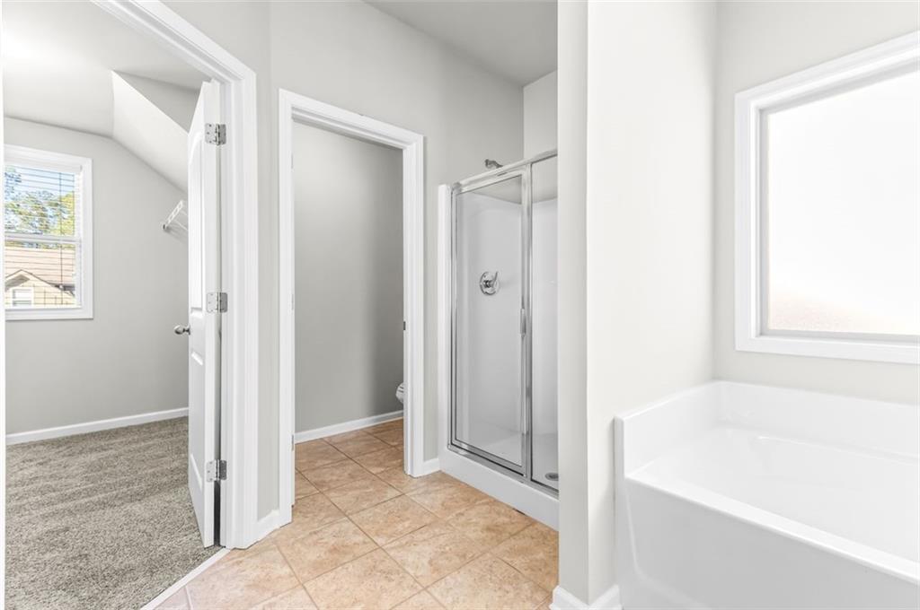 4237 Water Mill Drive Buford, GA 30519 - Photo 24 of 35 a view of a bathroom with bathtub