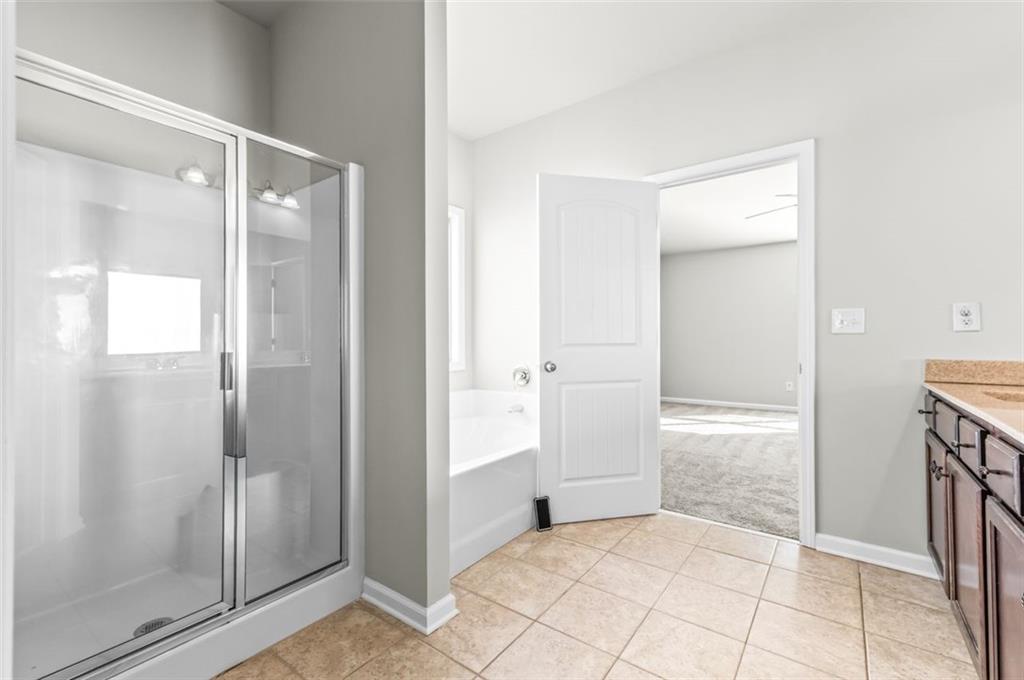 4237 Water Mill Drive Buford, GA 30519 - Photo 25 of 35 a bathroom with a shower and a glass door