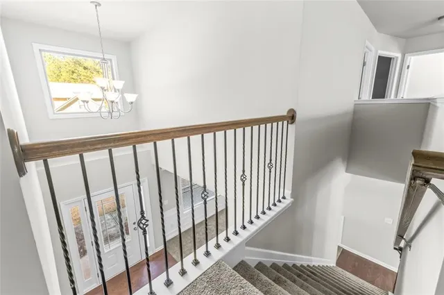 a view of hallway with wooden floor and stairs