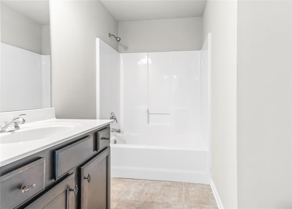 4237 Water Mill Drive Buford, GA 30519 - Photo 31 of 35 a bathroom with a granite countertop sink and a mirror