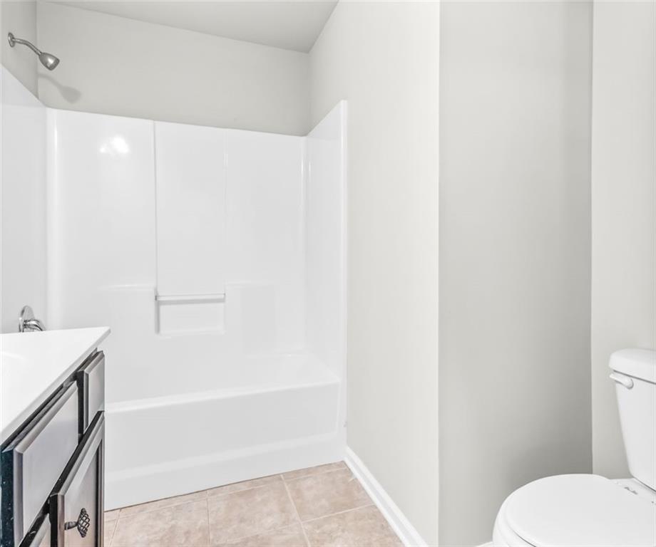 4237 Water Mill Drive Buford, GA 30519 - Photo 32 of 35 a bathroom with a toilet and a bathtub