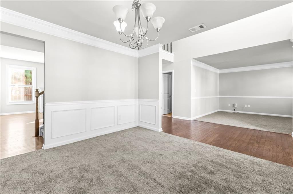 4237 Water Mill Drive Buford, GA 30519 - Photo 7 of 35 wooden floor in an empty room with a chandelier