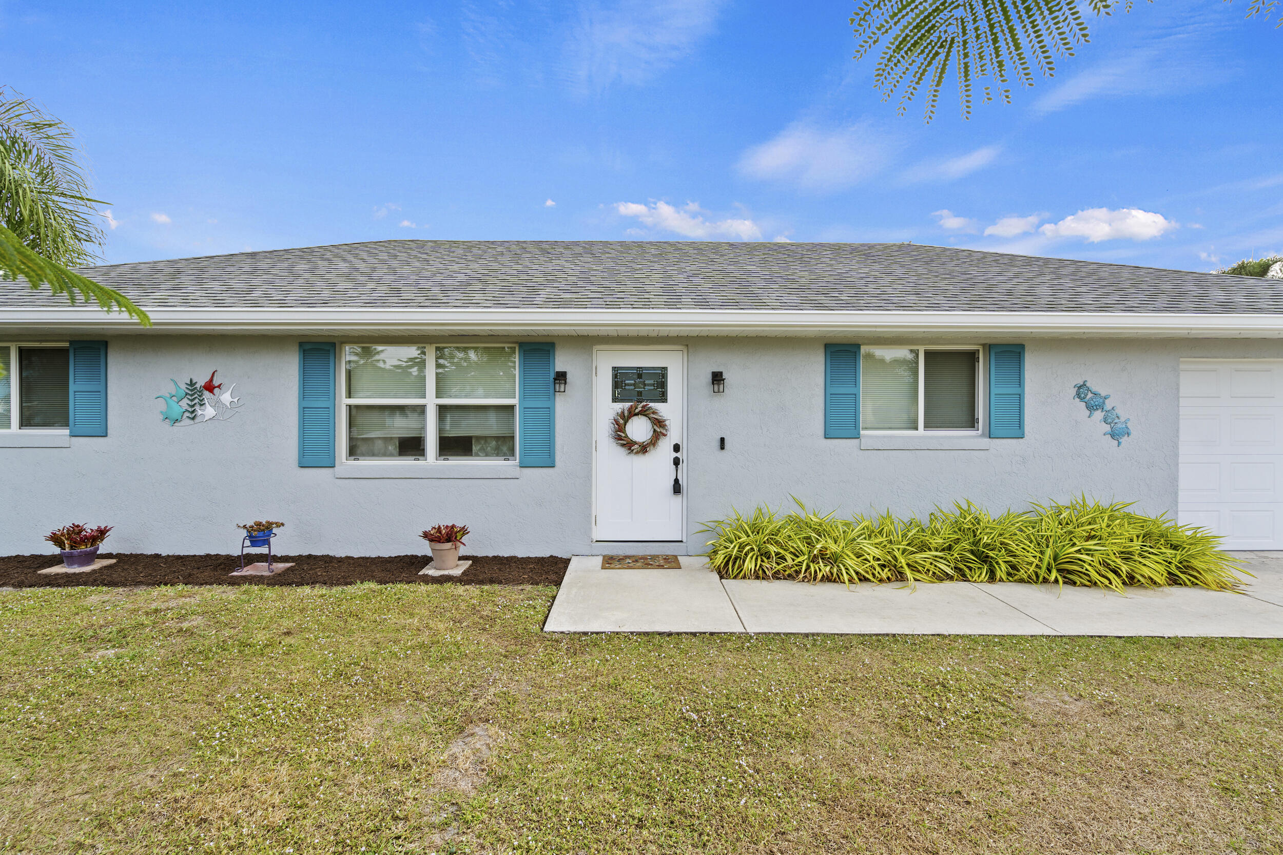 a front view of a house with garden