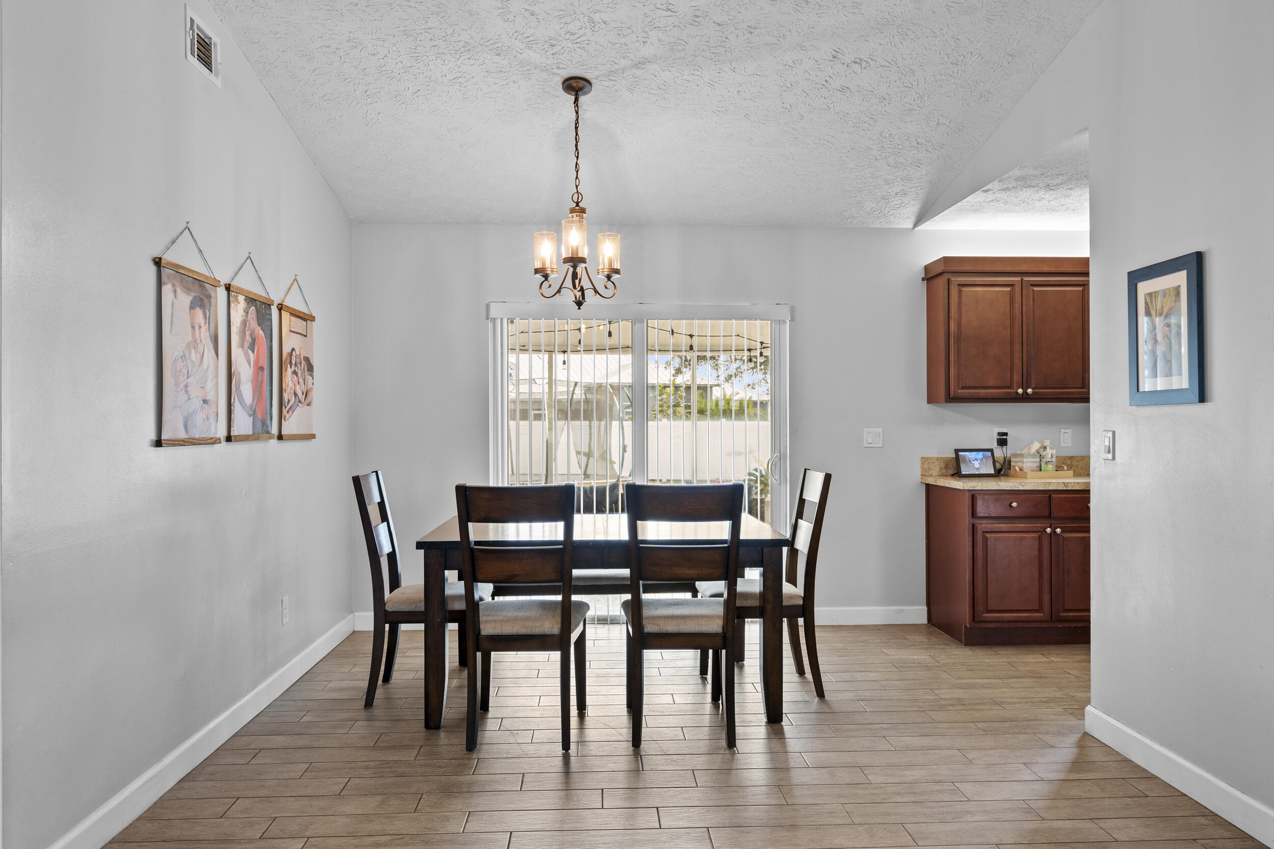 2121 Southeast Midtown Road Port St. Lucie, FL 34952 - Photo 12 of 42 a view of a dining room with furniture window and wooden floor