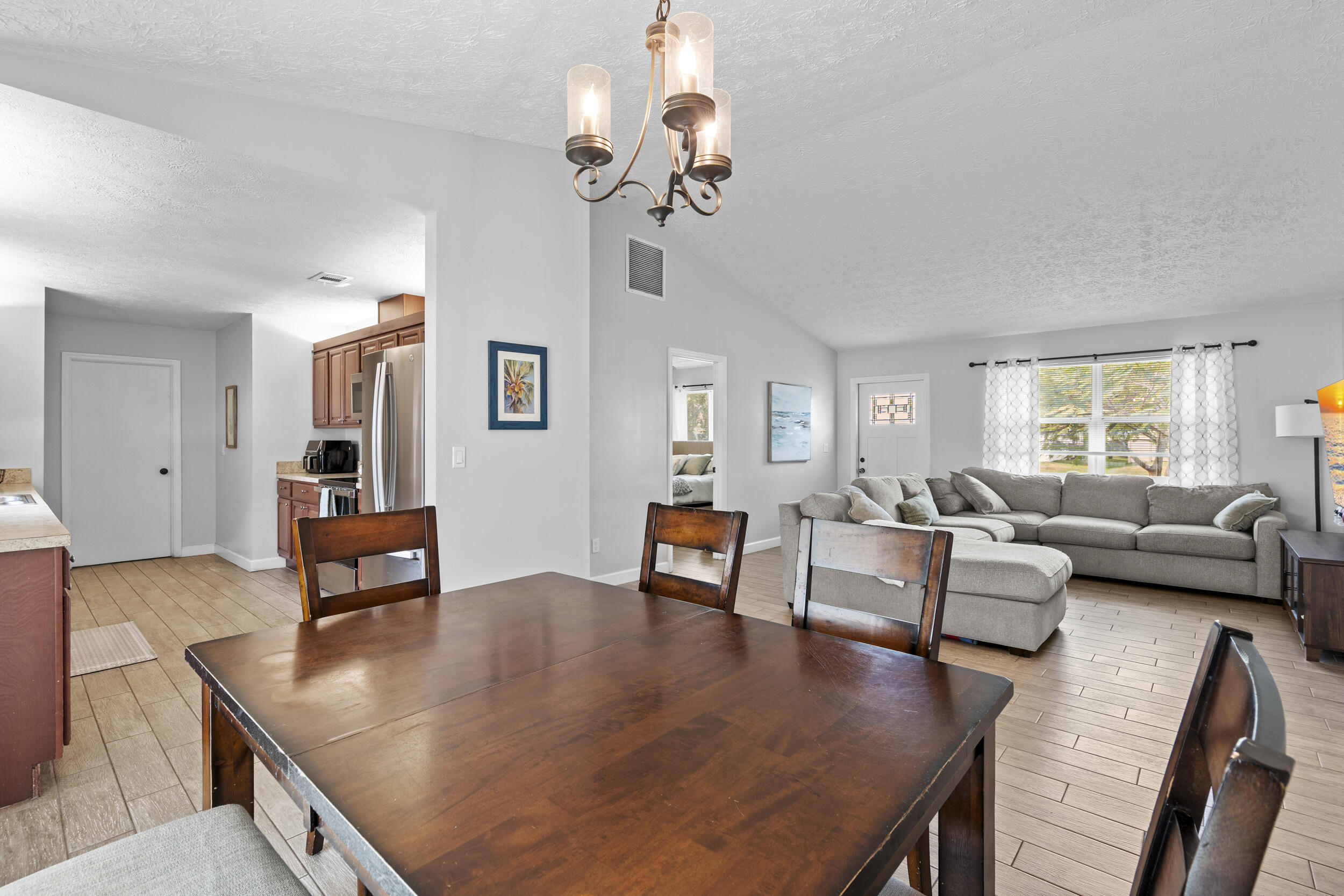 2121 Southeast Midtown Road Port St. Lucie, FL 34952 - Photo 14 of 42 a living room with furniture and a chandelier
