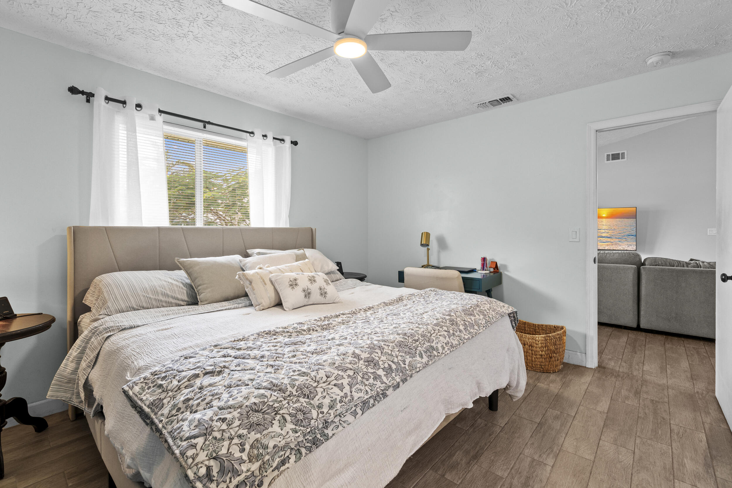 2121 Southeast Midtown Road Port St. Lucie, FL 34952 - Photo 20 of 42 a bedroom with a bed wooden floor and window