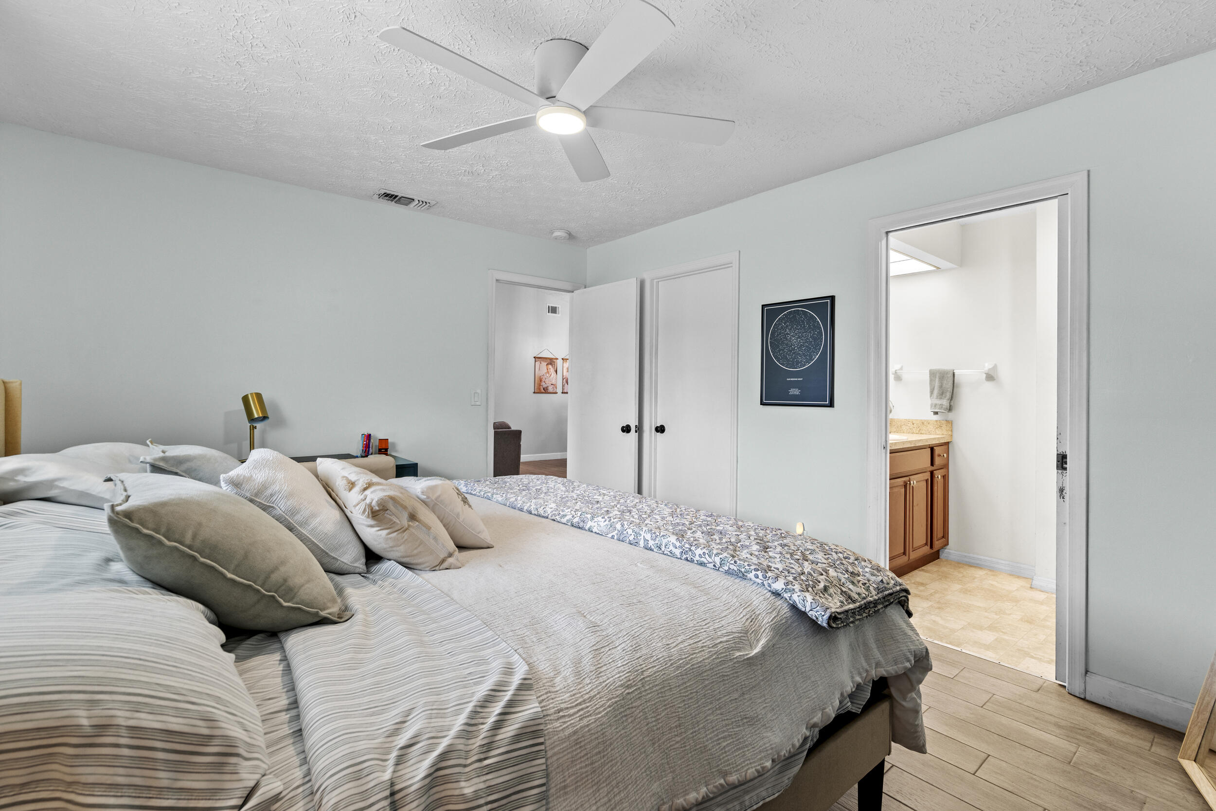 2121 Southeast Midtown Road Port St. Lucie, FL 34952 - Photo 23 of 42 a bedroom with a large bed and a chandelier