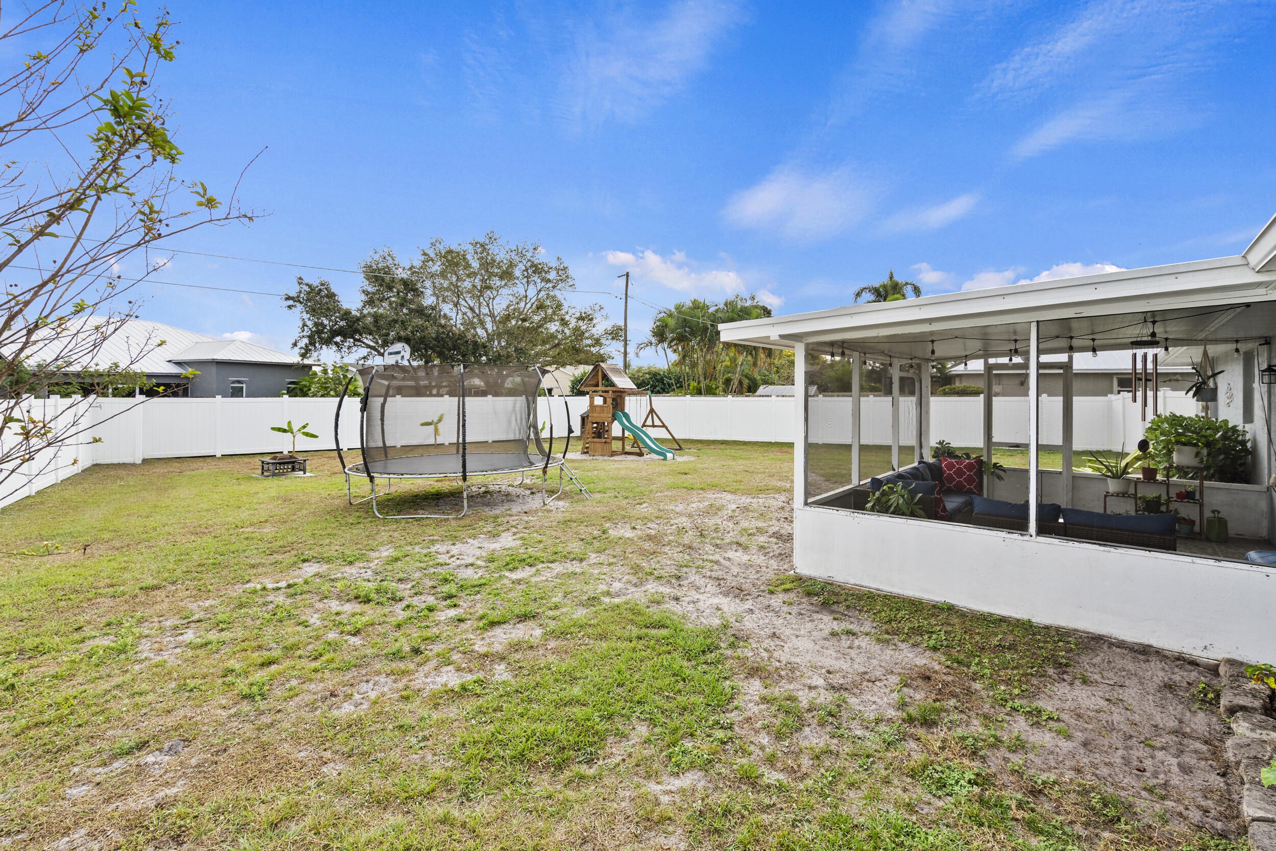 2121 Southeast Midtown Road Port St. Lucie, FL 34952 - Photo 25 of 42 a view of a swimming pool with an outdoor seating and a yard