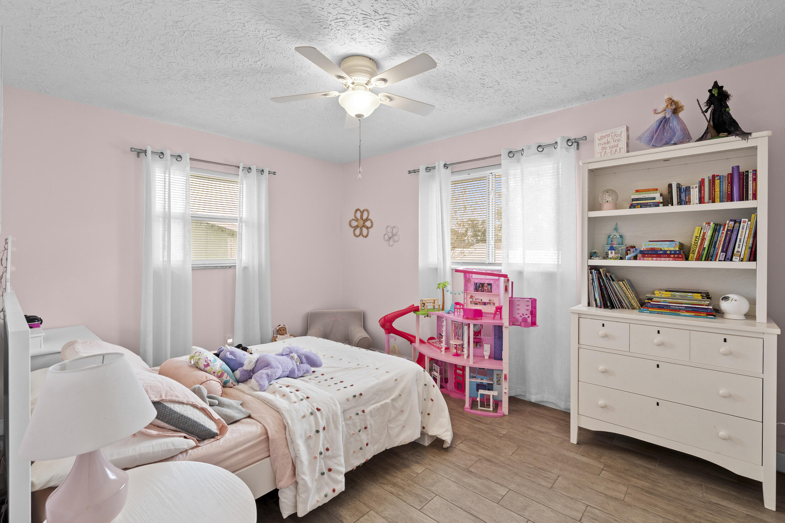 2121 Southeast Midtown Road Port St. Lucie, FL 34952 - Photo 26 of 42 a bedroom with a bed and a bookshelf