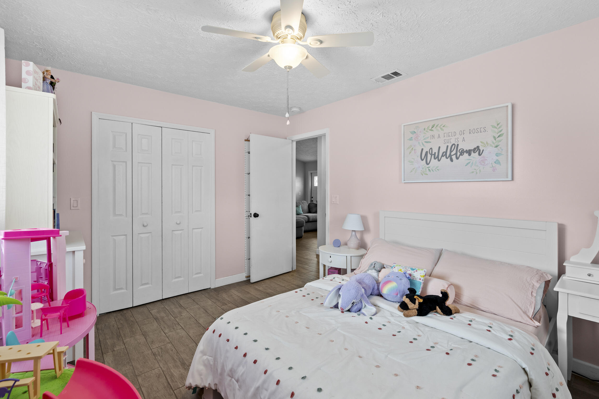 2121 Southeast Midtown Road Port St. Lucie, FL 34952 - Photo 27 of 42 a bedroom with a bed and a chandelier