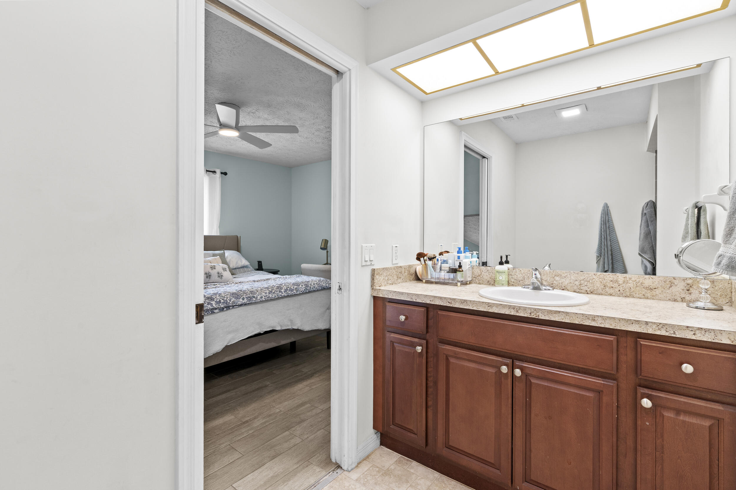 2121 Southeast Midtown Road Port St. Lucie, FL 34952 - Photo 28 of 42 a en suite bathroom with a sink and mirror