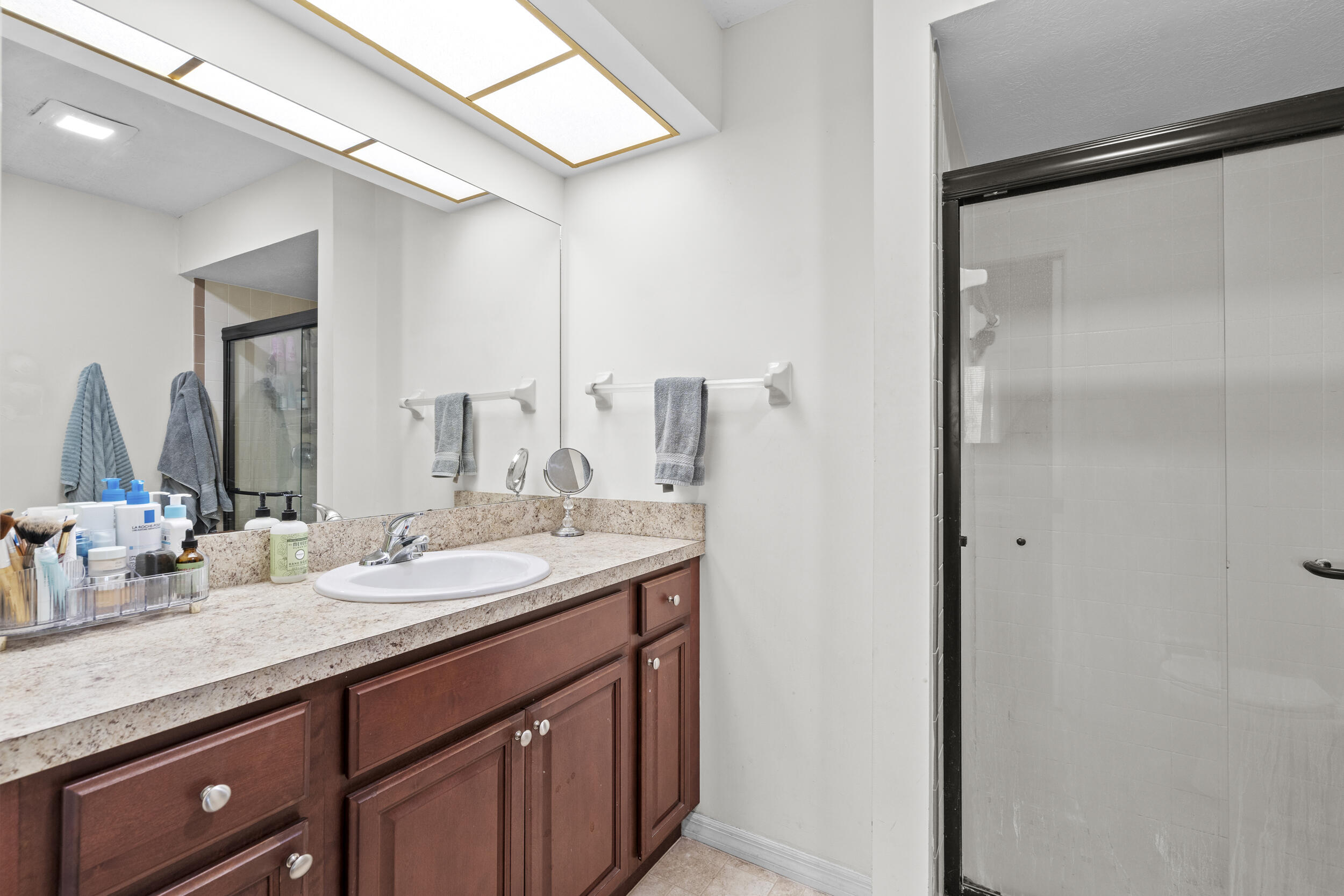 2121 Southeast Midtown Road Port St. Lucie, FL 34952 - Photo 29 of 42 a bathroom with a double vanity sink and a mirror