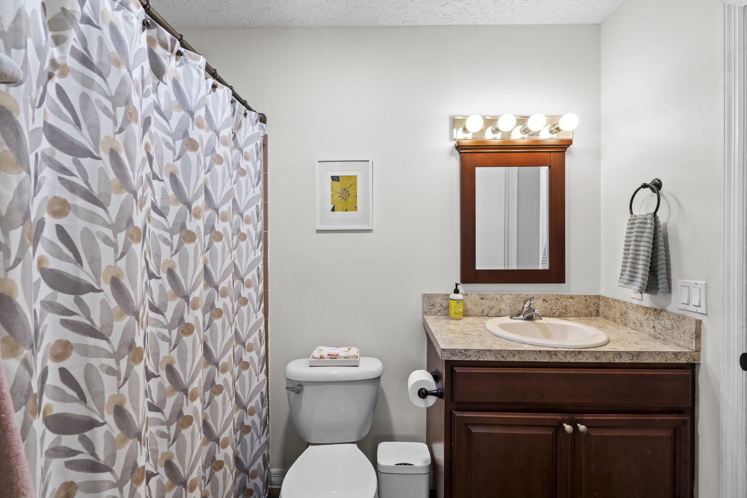 2121 Southeast Midtown Road Port St. Lucie, FL 34952 - Photo 30 of 42 a bathroom with a granite countertop sink and a toilet