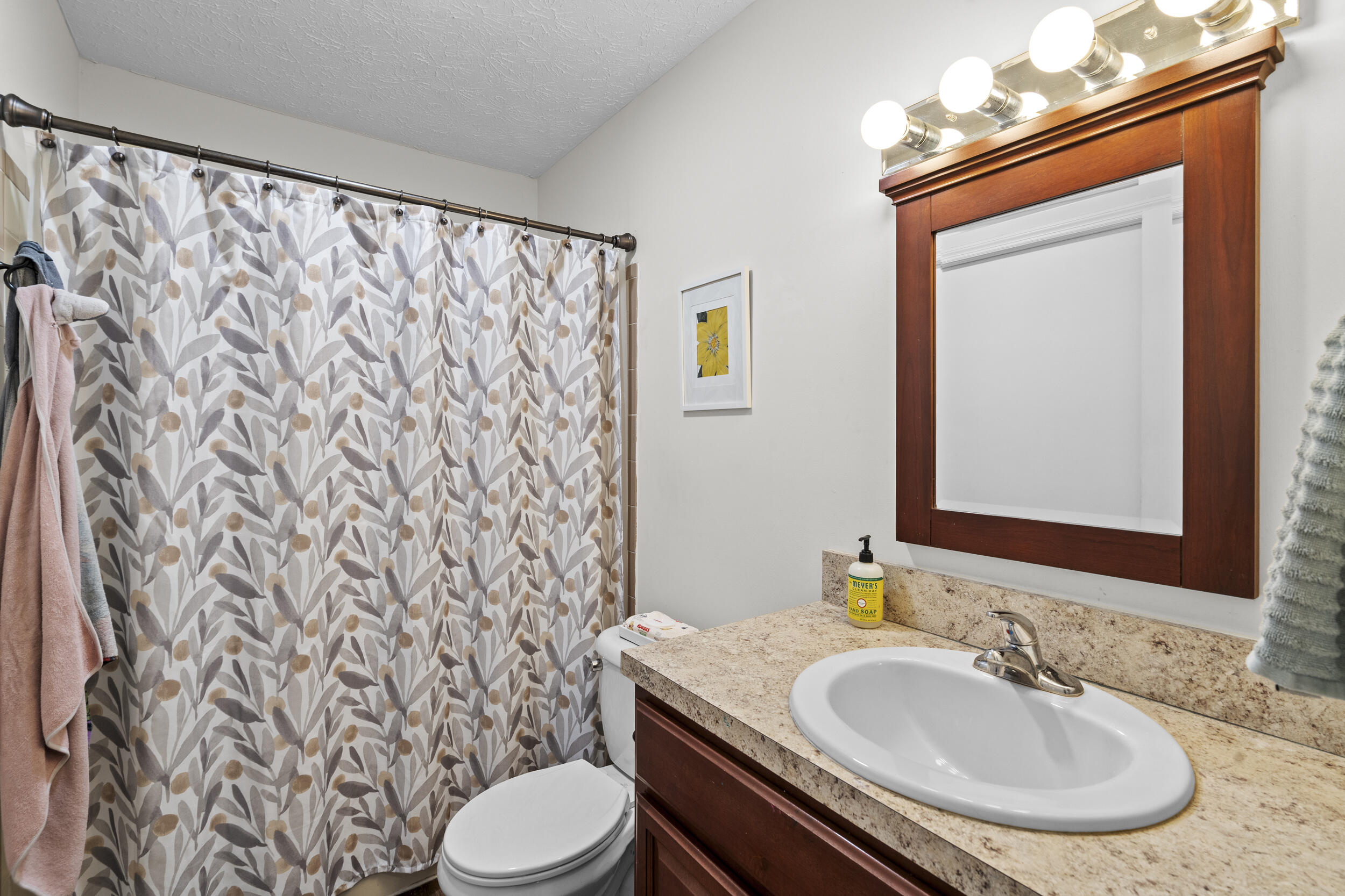 2121 Southeast Midtown Road Port St. Lucie, FL 34952 - Photo 31 of 42 a bathroom with a sink and a mirror