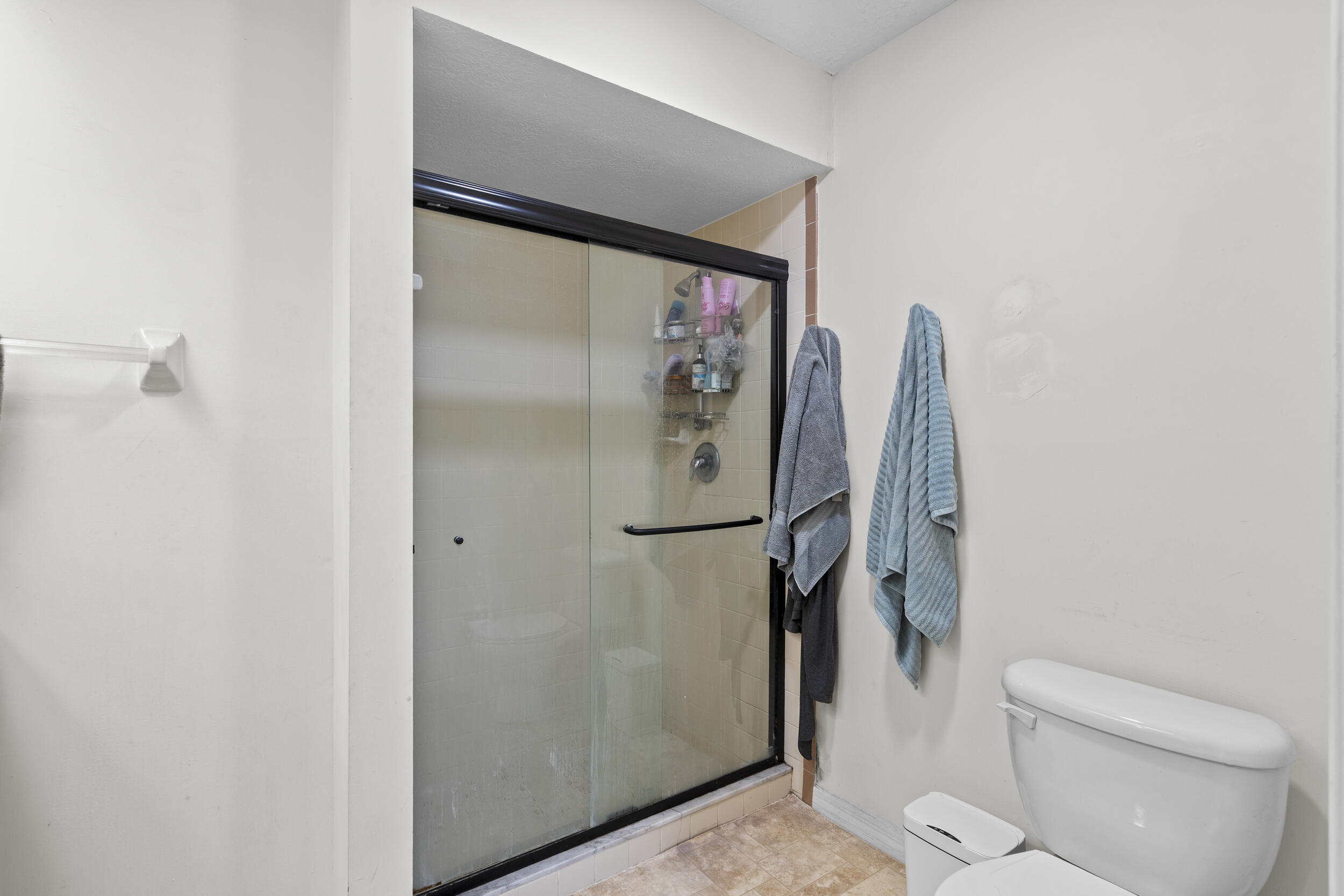 2121 Southeast Midtown Road Port St. Lucie, FL 34952 - Photo 32 of 42 a bathroom with a glass shower door