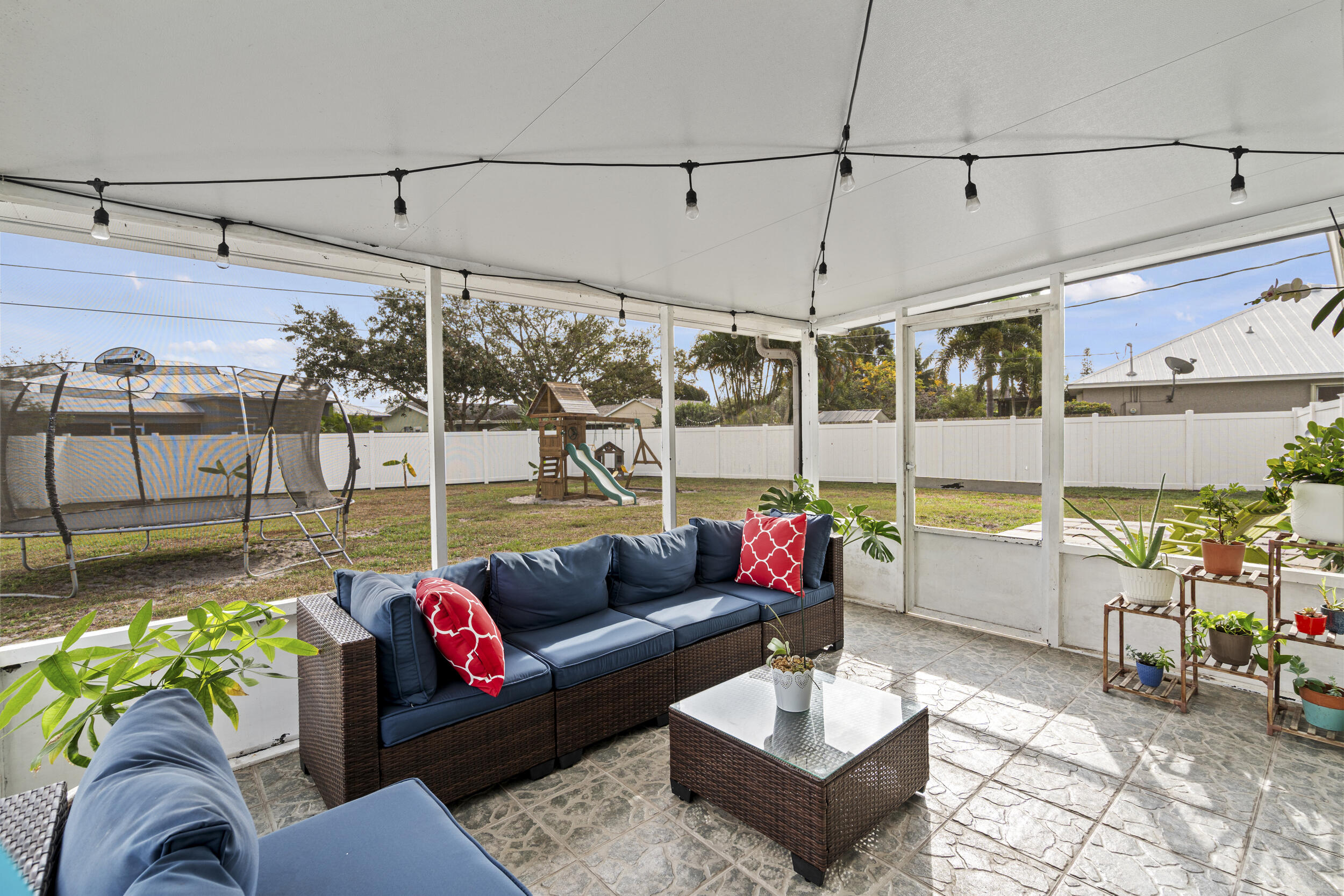 2121 Southeast Midtown Road Port St. Lucie, FL 34952 - Photo 37 of 42 a living room with patio furniture and a floor to ceiling window