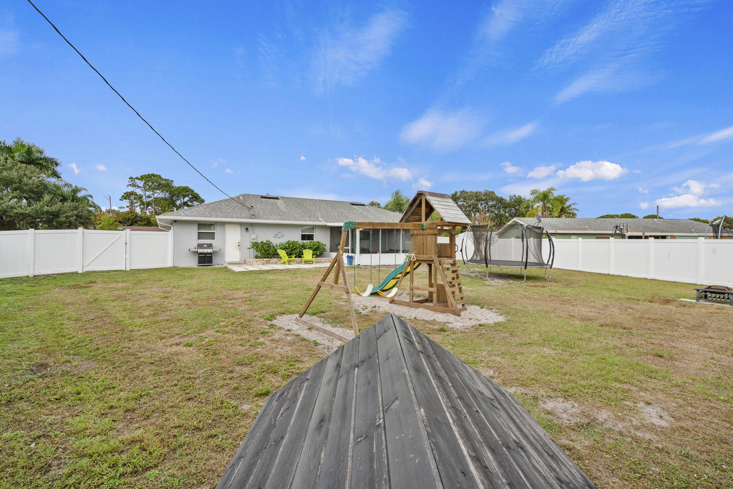 2121 Southeast Midtown Road Port St. Lucie, FL 34952 - Photo 39 of 42 a view of a house with swimming pool