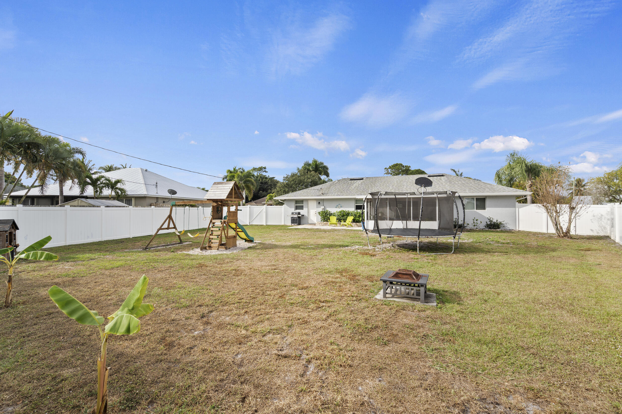 2121 Southeast Midtown Road Port St. Lucie, FL 34952 - Photo 40 of 42 a view of a house with a yard