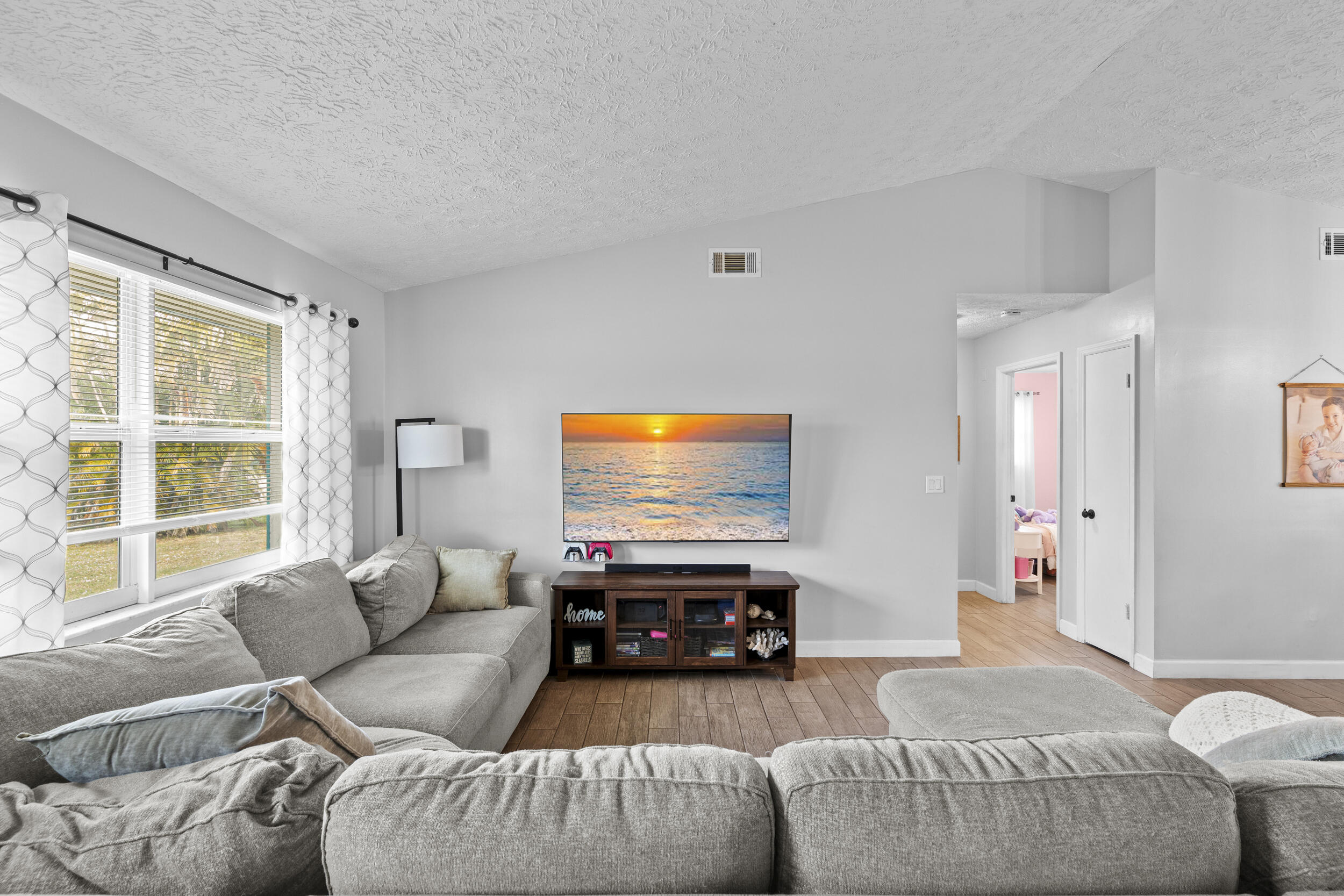 2121 Southeast Midtown Road Port St. Lucie, FL 34952 - Photo 7 of 42 a living room with furniture and a flat screen tv