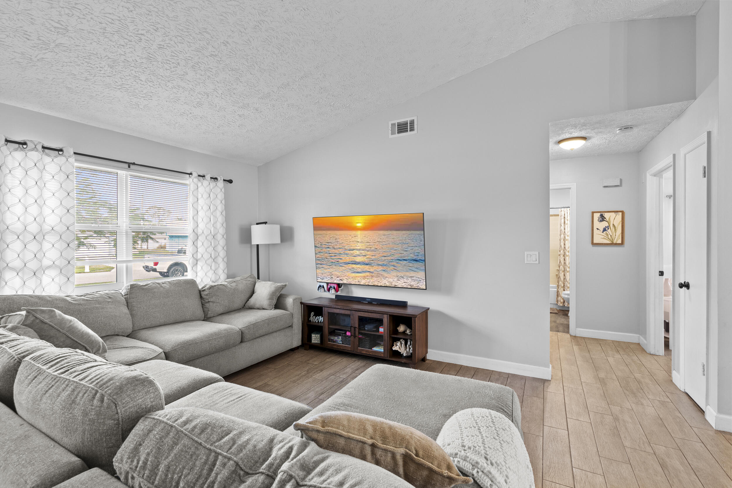 2121 Southeast Midtown Road Port St. Lucie, FL 34952 - Photo 10 of 42 a living room with furniture and a flat screen tv